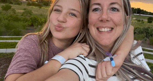 Kaci and her daughter Kaylee pose for a selfie in front of a beautiful sunset.