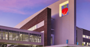 Photograph of a children's hospital at sunset with a heart logo